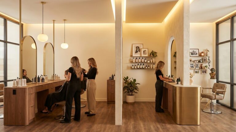 Modern salon showing two working models side by side, commission team and independent booth renters